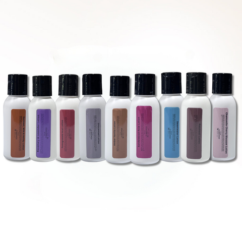 Set of white travel-sized bottles with black caps and color swatches on a white background