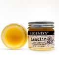 A jar of Legend's Greek Farm Lanolin Nipple Balm, with the lid off, showing the yellowish solid content inside. The label on the jar reads '100% Pure Anhydrous Lanolin'.