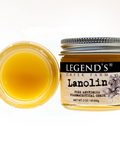 Jar of Legend's Creek Farm Lanolin with a lid off, showing the yellowish substance inside.