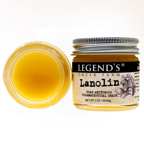 Jar of Legend's Creek Farm Lanolin with a lid off, showing the yellowish substance inside.