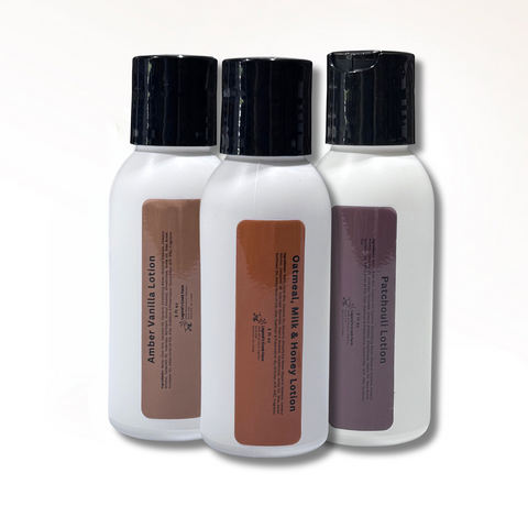 Three bottles of lotion with black caps on a white background